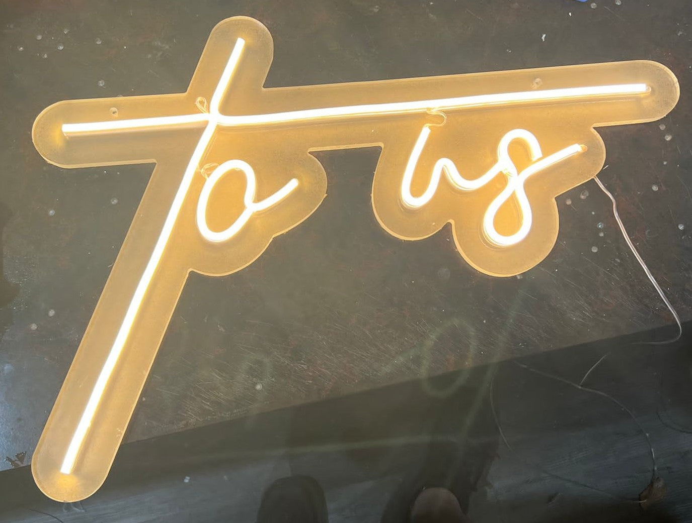 a neon sign with a cross on top of it