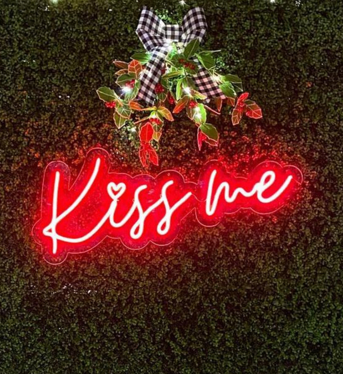 a neon sign that says kiss me on it