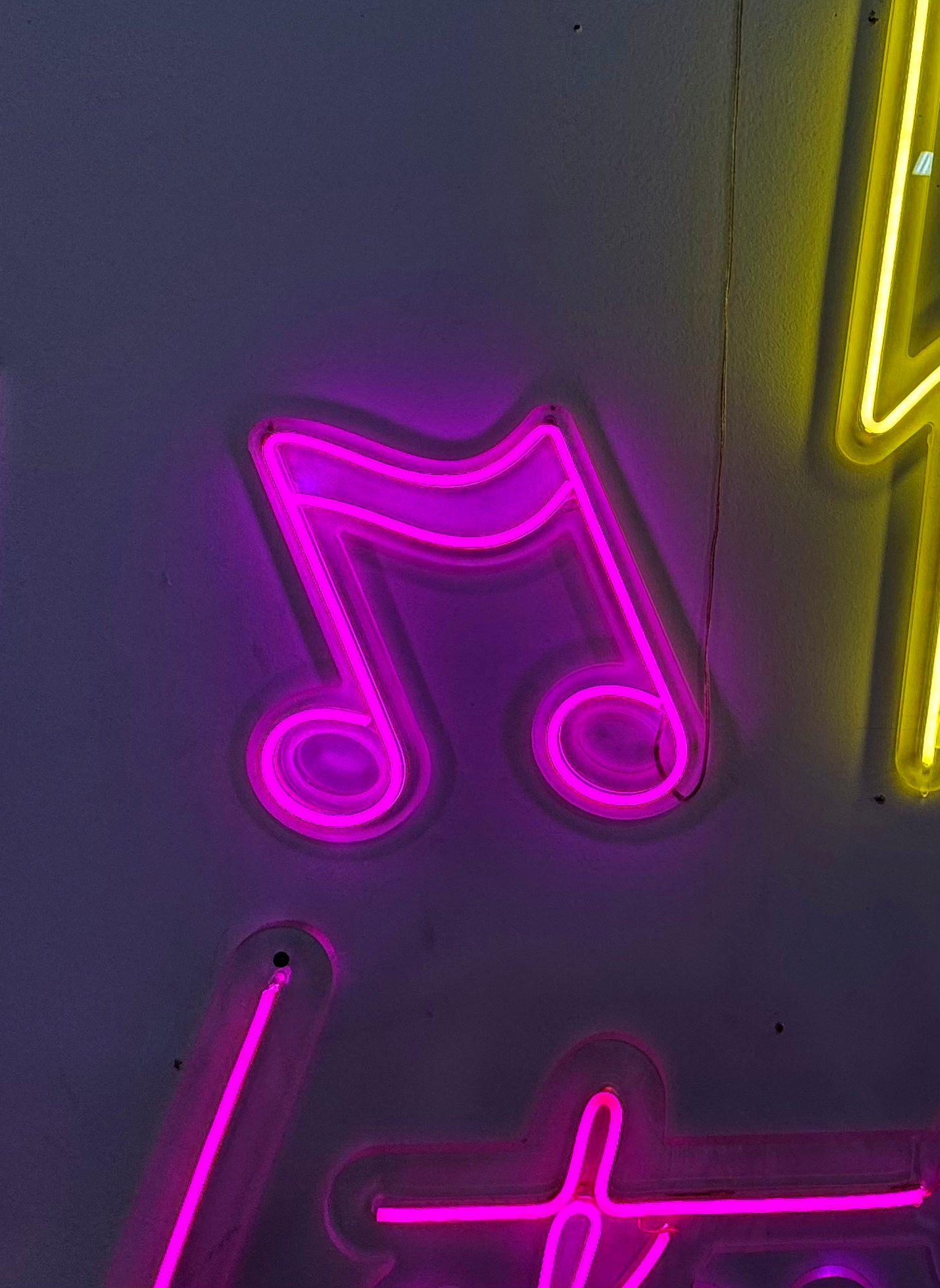 a neon sign with a musical note on it