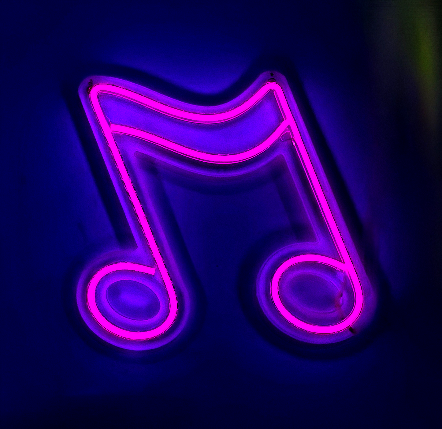 a neon sign with a musical note on it