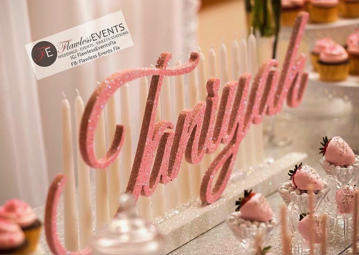 a table topped with cupcakes and cupcake toppers