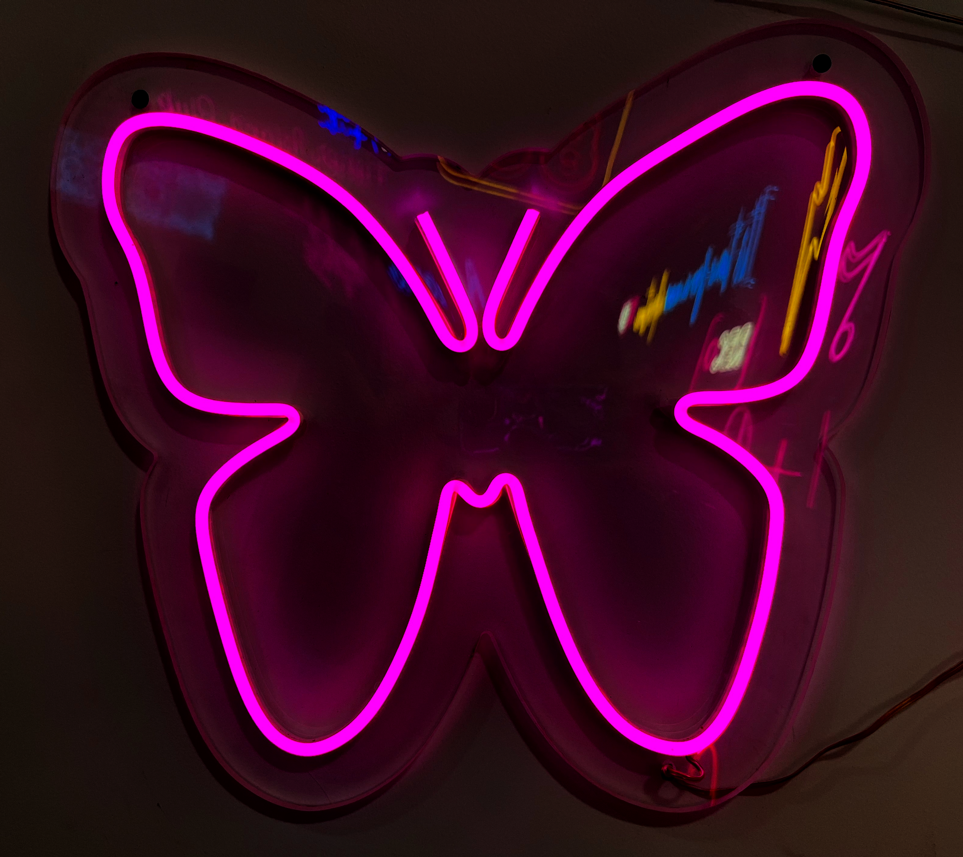 a neon sign with a pink butterfly on it