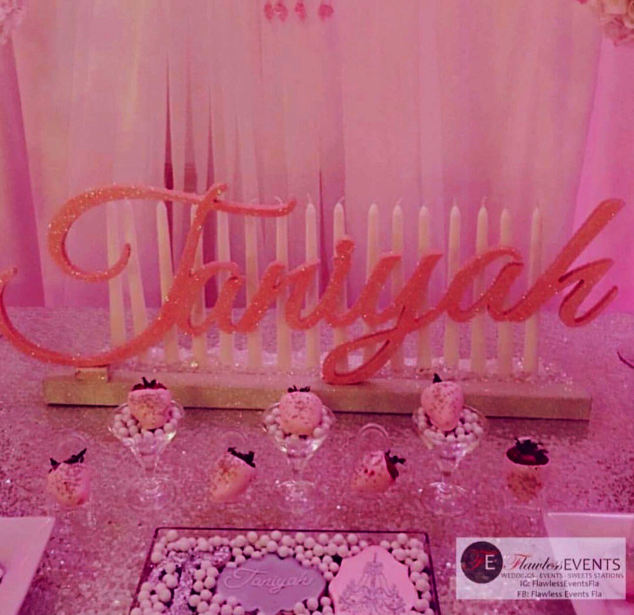 a table topped with a cake and cupcakes